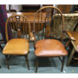 A 20th century elm Windsor style armchair and side chair both with carved splats depicting