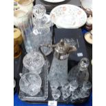 A cut glass liquor decanter and shot glasses, a claret jug, a pressed glass cream jug and sugar bowl