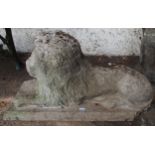 A 20th century stoneware garden statue of a lion passant, 35cm high x 65cm long x 26cm wide