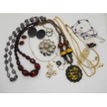 A string of cherry amber coloured beads, weight 59.5gms, a gold plated Wedgwood brooch and other