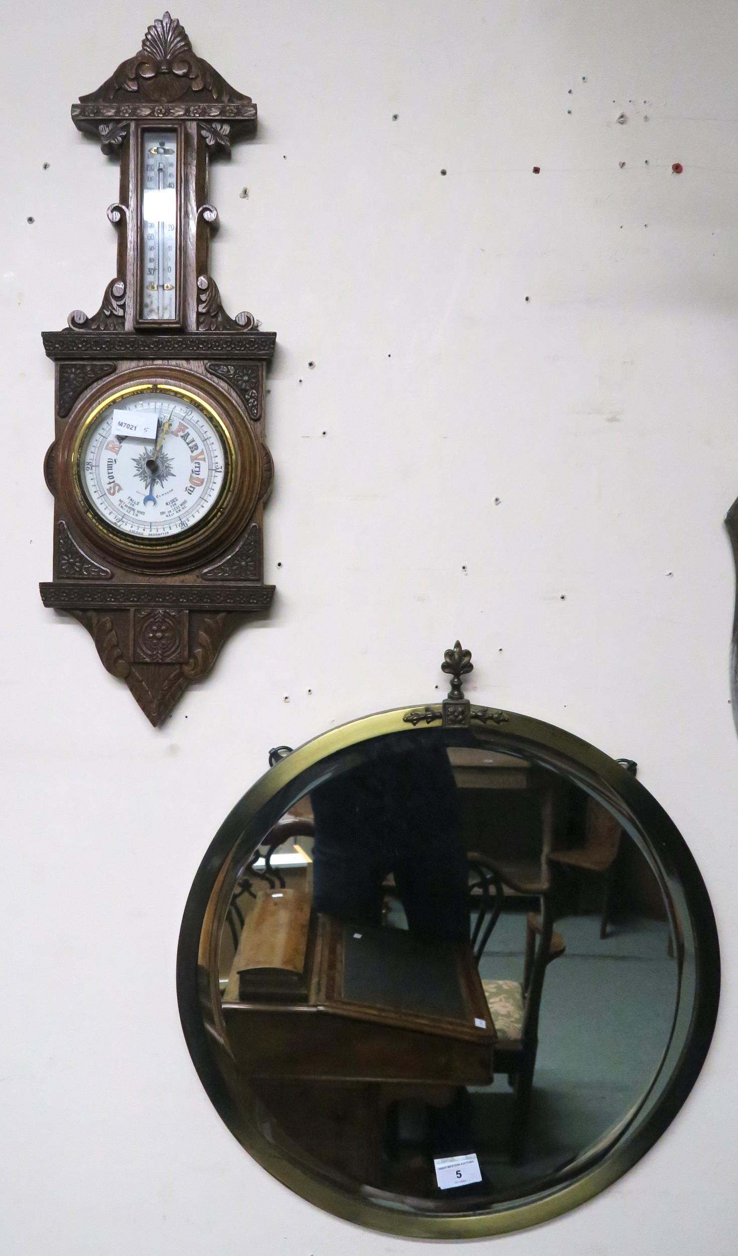 A 20th century carved oak barometer/thermometer and brass framed circular wall mirror (2)