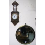 A 20th century carved oak barometer/thermometer and brass framed circular wall mirror (2)