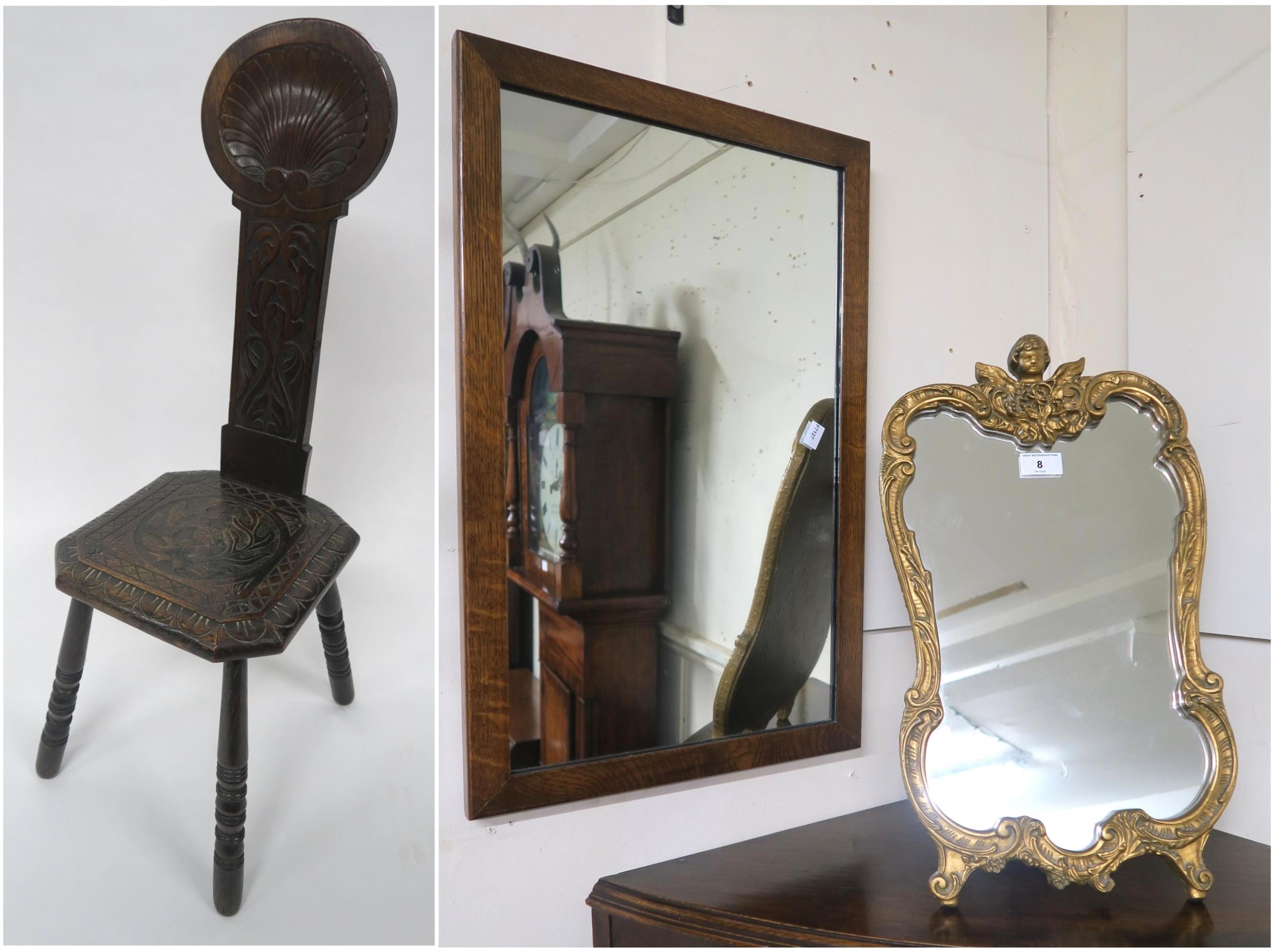 A 20th century oak spinning chair, a 20th century rococo style mirror and an oak framed wall