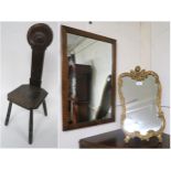 A 20th century oak spinning chair, a 20th century rococo style mirror and an oak framed wall