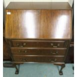 A 20th century mahogany bureau with fall front writing compartment over three drawers on cabriole