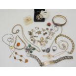 A silver charm bracelet, with attached and loose, silver and white metal charms and other items