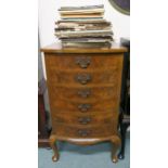 A 20th century walnut bow front six drawer music cabinet with assorted sheet music on cabriole