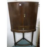 An early 20th century oak bow fronted corner cabinet, 146cm high x 78cm wide x 48cm deep Condition