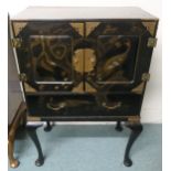 An early 20th century black lacquer chinoiserie cabinet with pair of cabinet doors painted with