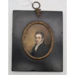 An early-C19th portrait miniature of a gentleman in a black coat, with white cravat; in ebonised