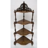 A Victorian burr walnut four tier corner what-not with serpentine front shelves, turned uprights