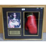 An Everlast boxing glove signed by Lennox Lewis, World Heavyweight Champion, framed under glass