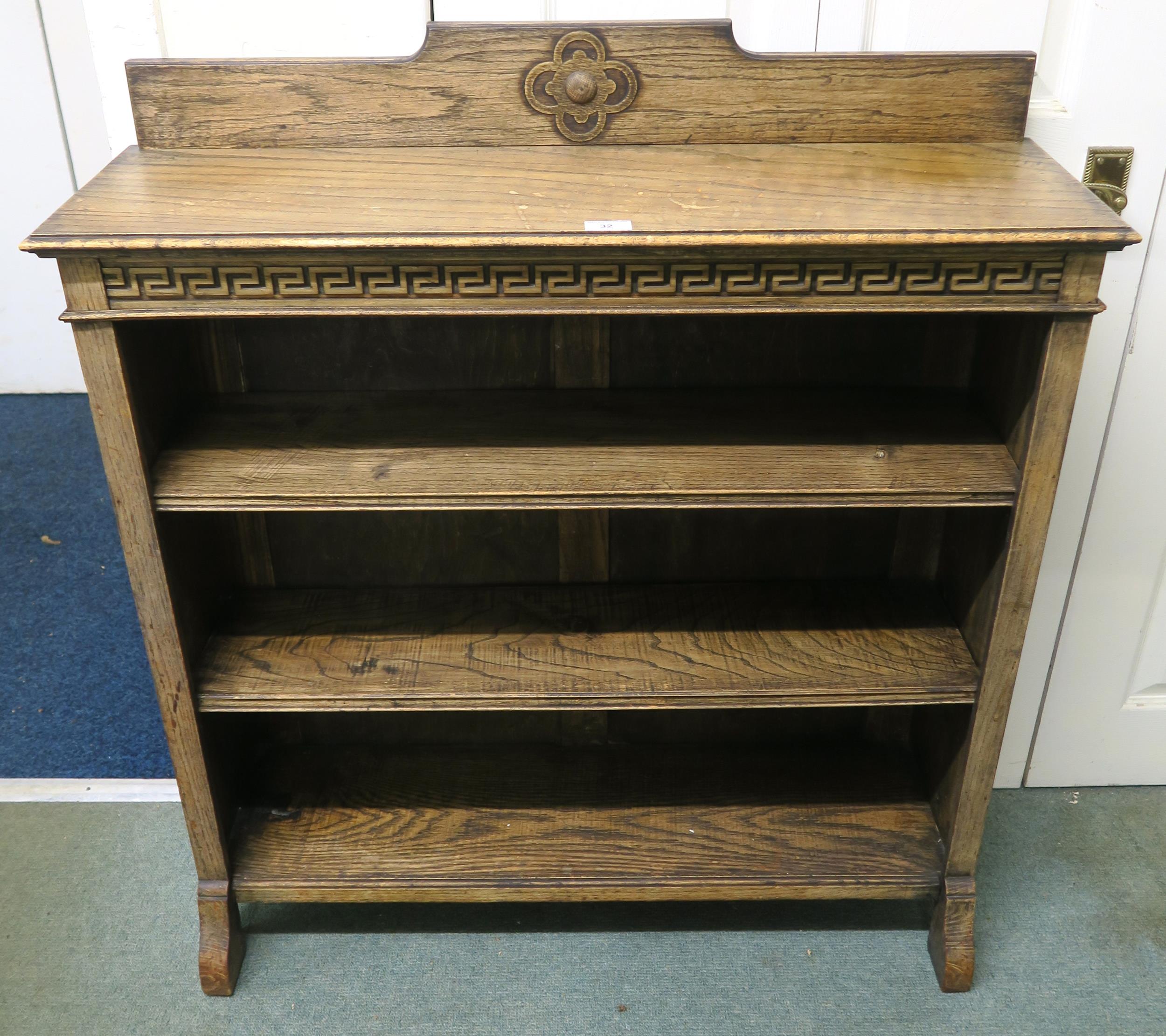 A 20th century oak three tier open bookcase with Grecian key design, 103cm high x 91cm wide x 27cm