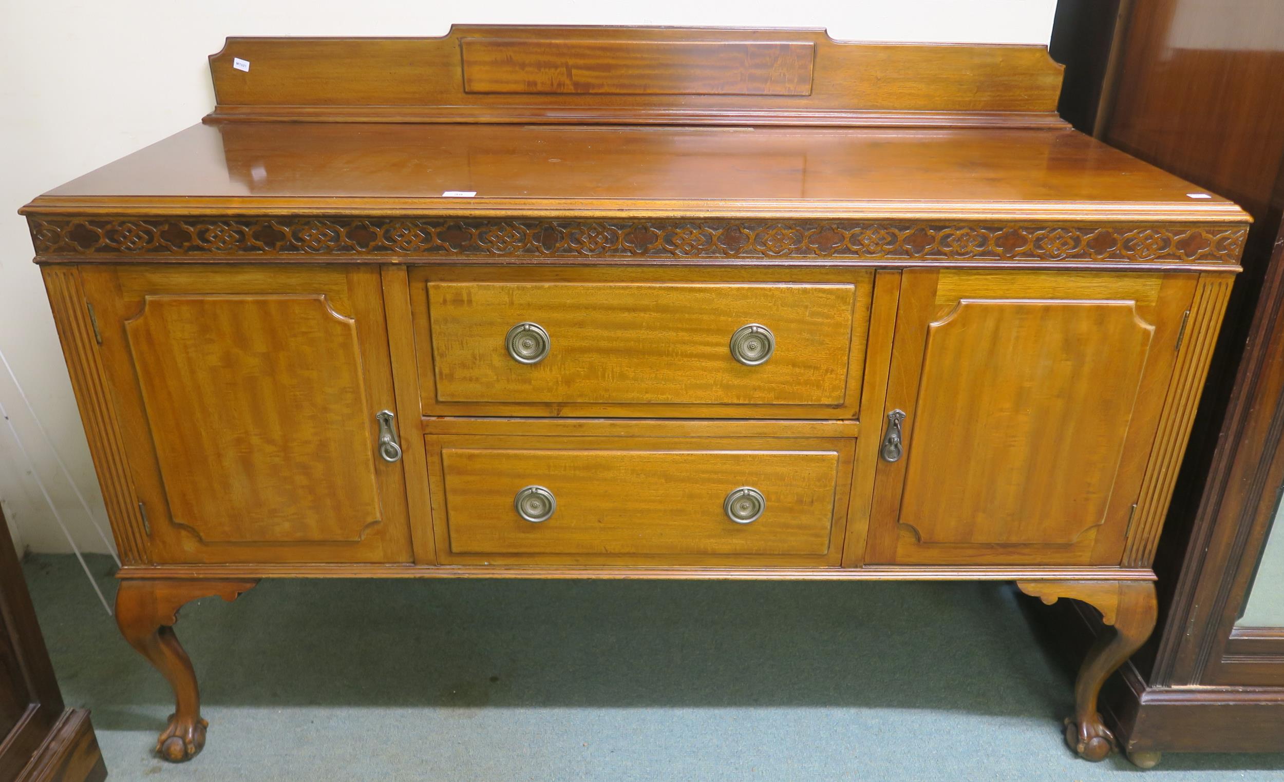 An early 20th century mahogany sideboard with two central drawers flanked by cabinet doors on