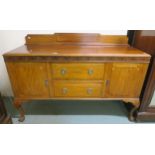 An early 20th century mahogany sideboard with two central drawers flanked by cabinet doors on