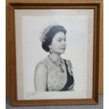 A framed photographic portrait of Queen Elizabeth II by Anthony Buckley, signed by the