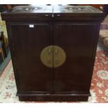 A 20th century Oriental hardwood drinks cabinet with pair of fold out top concealing marble insert