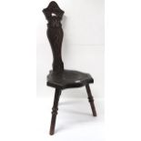 A Victorian stained oak spinning chair, the vase shaped splat carved with sinuous foliage, above a