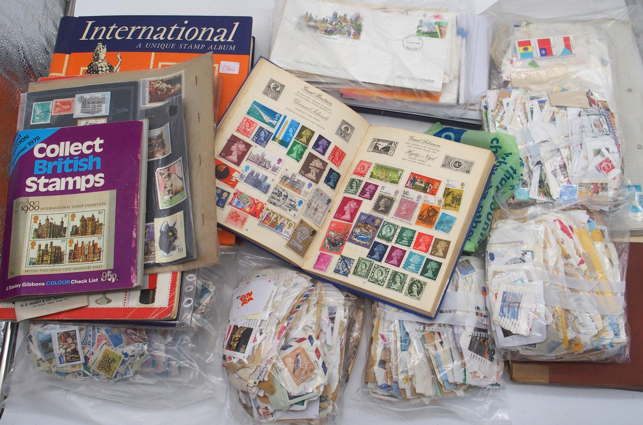 A box containing various stamps albums, including an International Unique Stamp Album, partially