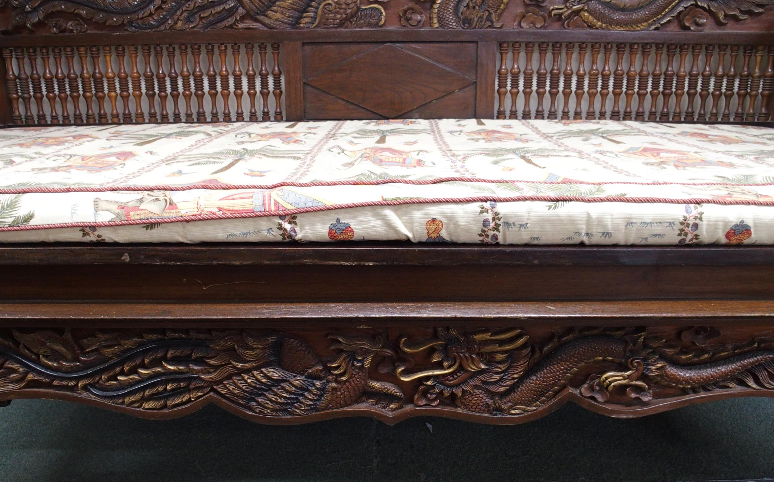 A contemporary Oriental hardwood day bed with carved back depicting phoenix and dragon over - Image 4 of 7