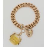A 9ct gold wide curb chain bracelet with heart shaped clasp, and a 9ct gold citrine fob seal.