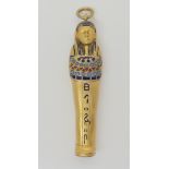 A gilded white metal enamelled propelling pencil in the shape of an Egyptian Sarcophagus, open