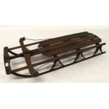 A 20th century beech and iron child's sled, 115cm long x 58cm wide x 19cm high Condition Report: