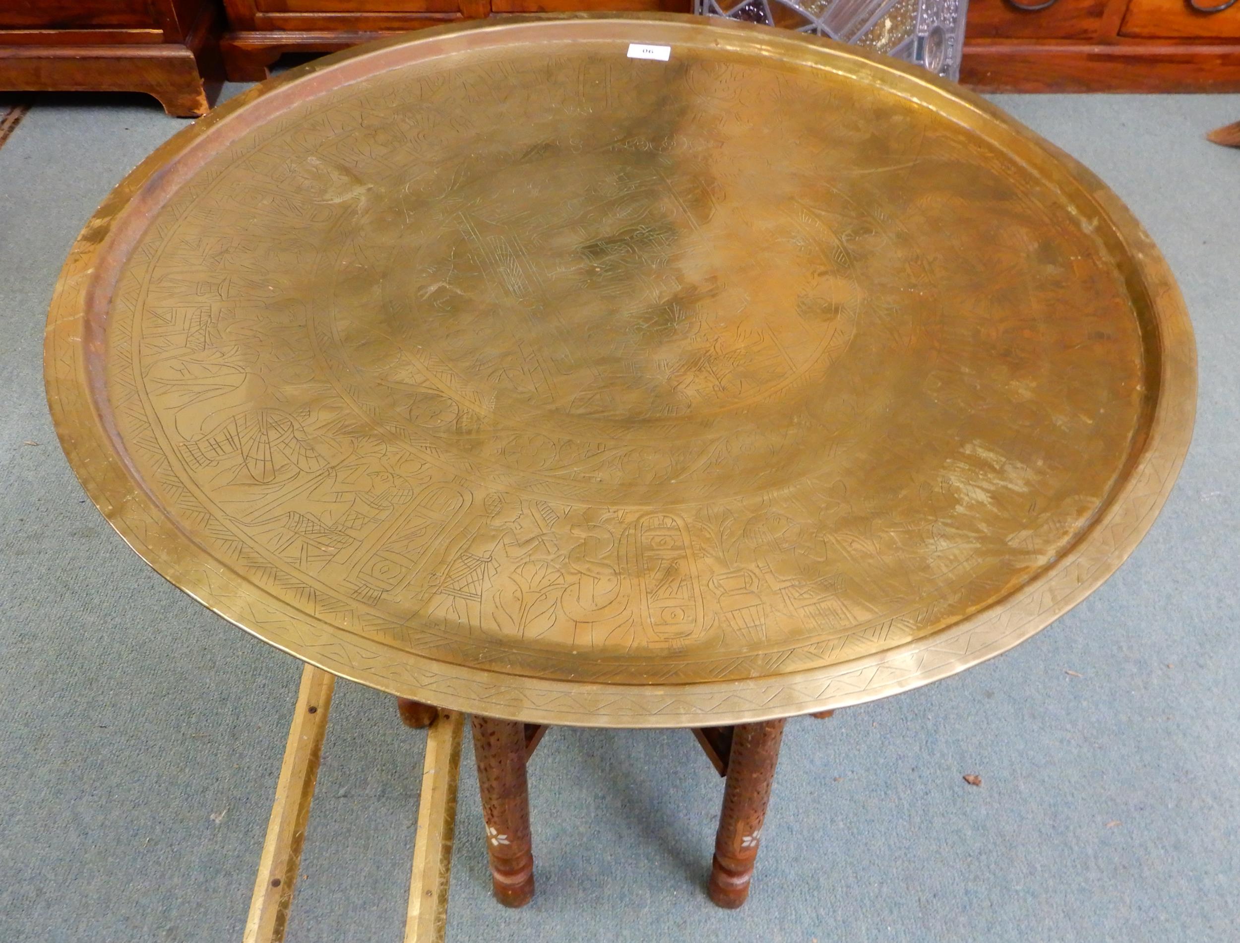 A 20th century circular brass topped Moorish folding table with bone inlaid folding base, 58cm