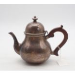 A George VI silver teapot, of baluster form, with a bell finial and a wooden handle and