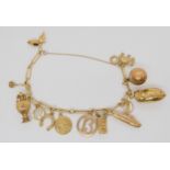 A 9ct gold charm bracelet hung with thirteen 9ct gold and yellow metal charms to include  a