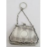 A George V silver purse, the shaped body with a scrolling border, with bands of engine turned