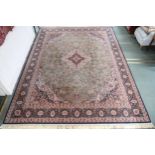 A green ground fine machine woven Keshan rug with dark blue and cream central medallion, matching