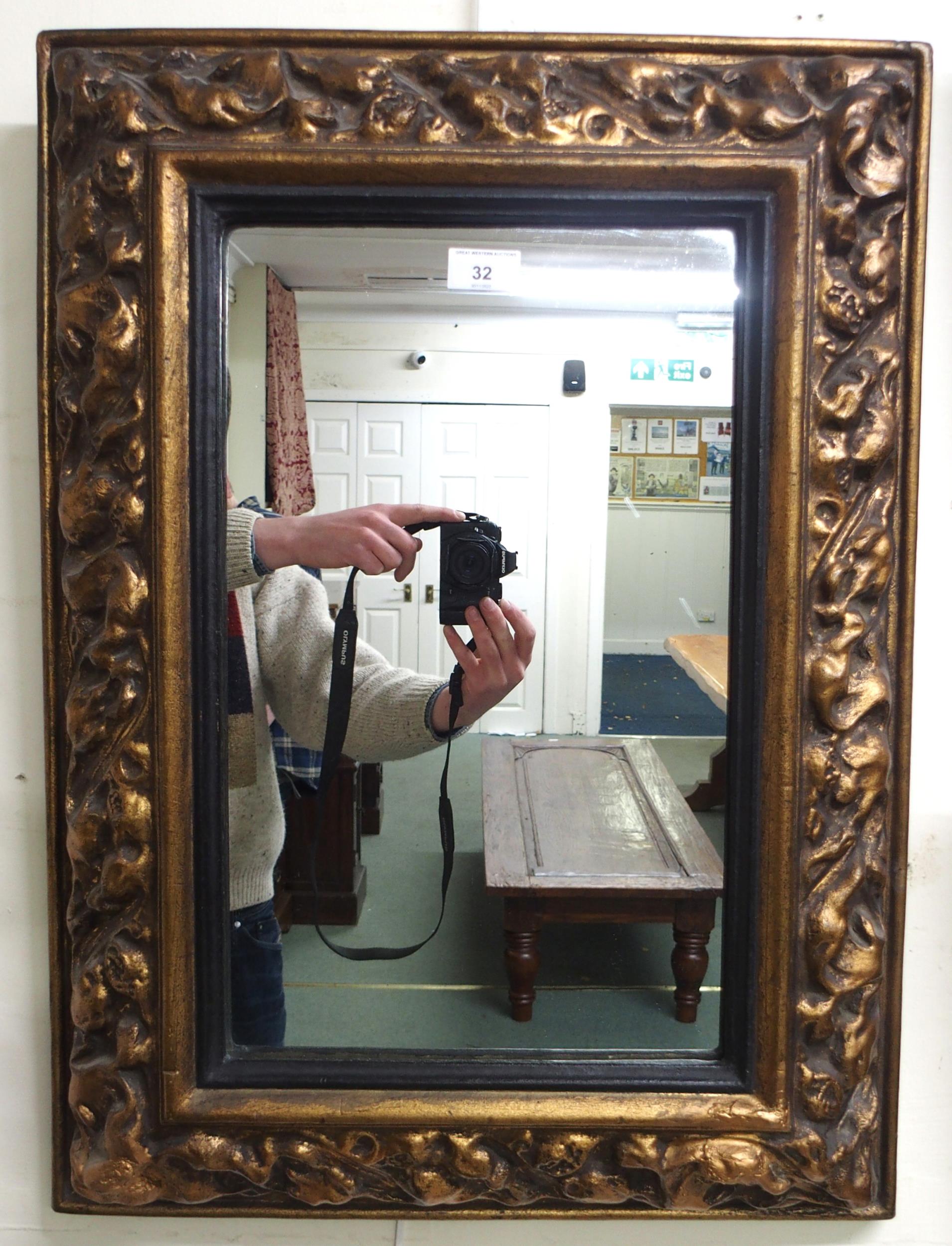 A 20th century gilt gesso style cushion framed wall mirror, 69cm high x 51cm wide and two walking