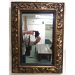 A 20th century gilt gesso style cushion framed wall mirror, 69cm high x 51cm wide and two walking