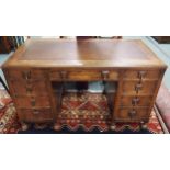A 20th century oak pedestal desk with embossed skiver over single long drawer flanked by four