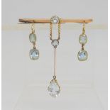 A 15ct gold aquamarine pendant necklace, with matching earrings and a 9ct brooch. Chain length 44cm,
