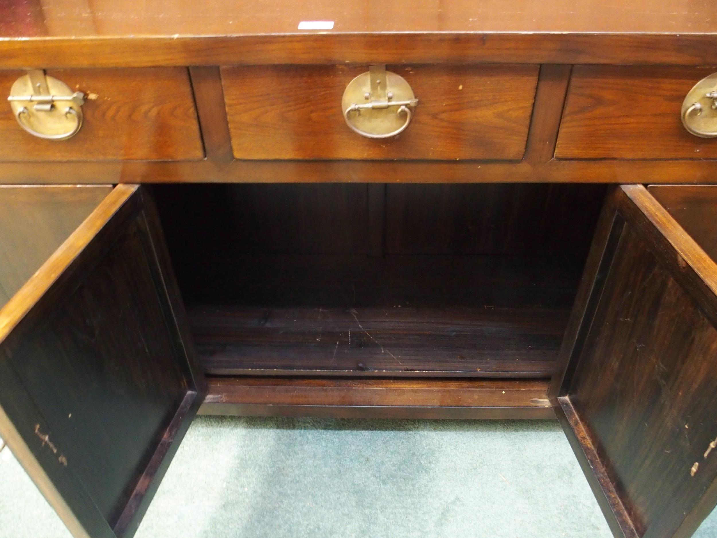 A 20th century Oriental hardwood sideboard with scroll end top over three drawers over pair of - Image 6 of 6