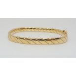 A 9ct gold twist pattern square bangle, inner dimensions 6cm x 5.2cm, weight 9.9gms Condition