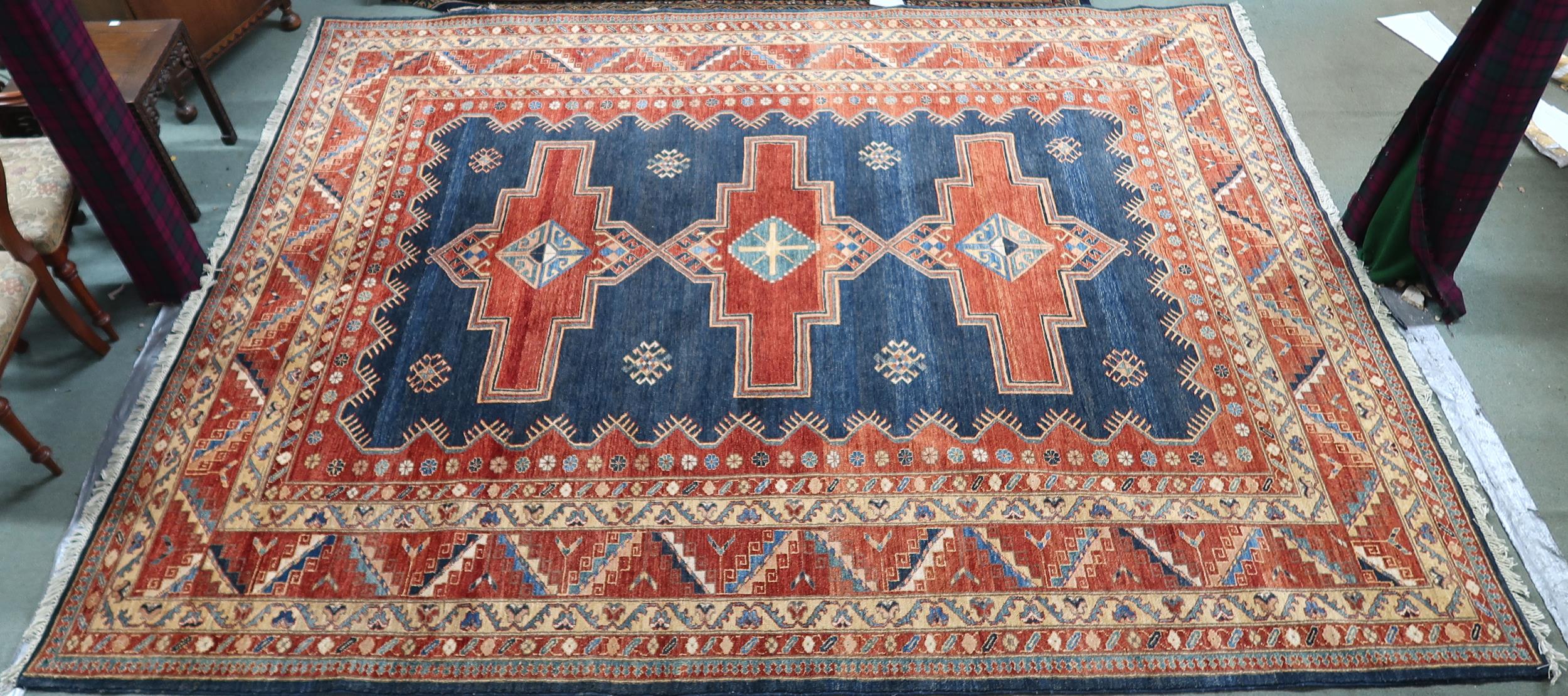 A dark blue ground Pakistani super Garous rug with three geometric medallions and multicoloured