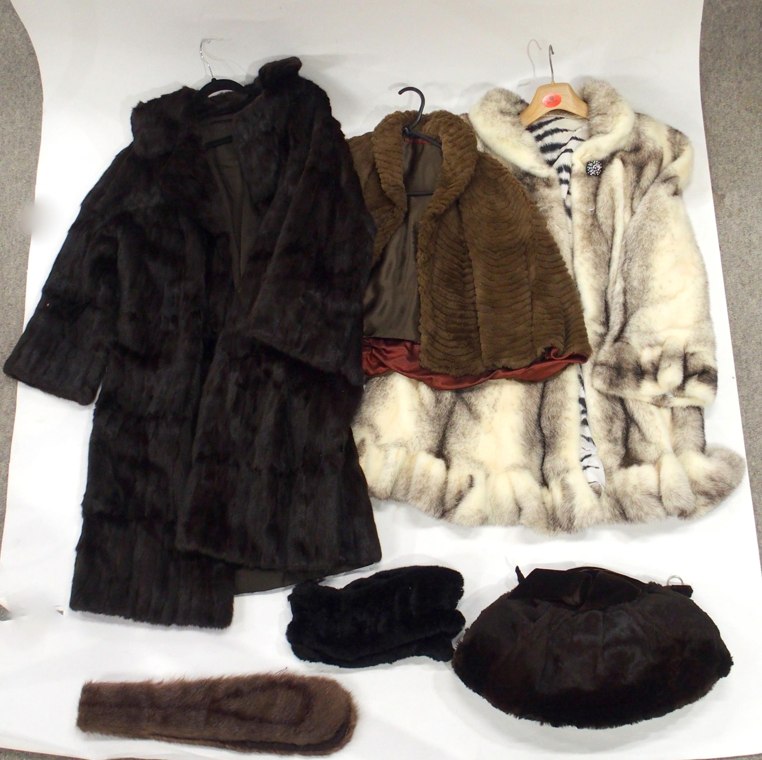 A fox fur coat, other fur jackets, a Karter velvet and fur muff bag, an animal skin floor rug etc