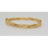 A 9ct gold barley twist bangle, inner dimensions 6cm x 5.5cm, weight 10.3gms Condition Report: