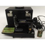 A cased Singer Featherweight convertible portable sewing machine model 222k serial number EM235228