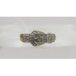 A gold plated sterling silver buckle shaped ring, set with brilliant diamond accents to the highly