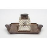 An Edwardian silver inkstand, of rectangular form with upturned carrying handles, on four ball feet,