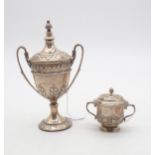 A silver miniature trophy cup and cover, the body with repousse acanthus leaf decoration, with a