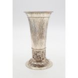 A German silver trumpet vase, the body hammered, with a band of scrolling openwork, the circular