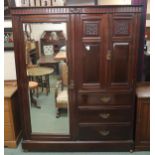 A Victorian mahogany mirror door compactum wardrobe with single mirror door to the left of pair of