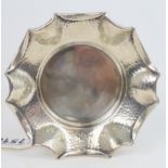 A Victorian silver arts and crafts style dish, the body with a hammered finish, with a fold over pie