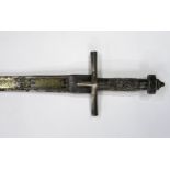 A NORTHEAST AFRICAN KASKARA SWORD The Damascene blade inlaid with yellow metal Arabic script along