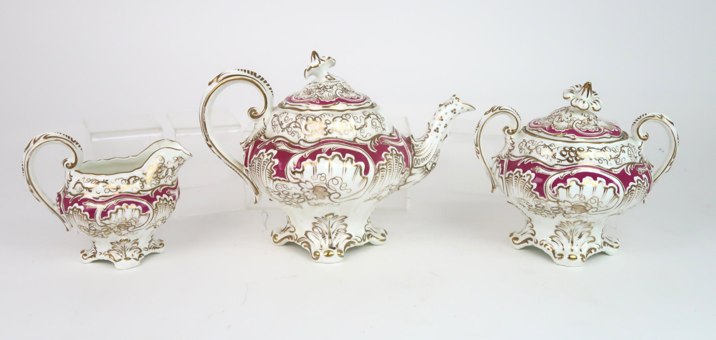 A ROCKINGHAM STYLE TEASET of moulded rococo design, the white ground with gilt vine and grape - Image 3 of 7